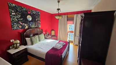 a red bedroom with a bed with a red wall at Classic Charm of an Old Porto free parking in Vila Nova de Gaia