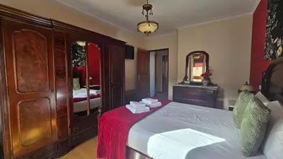 a bedroom with a bed with a dresser and a mirror at Classic Charm of an Old Porto free parking in Vila Nova de Gaia