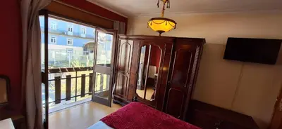 a room with a bed and a window with a tv at Classic Charm of an Old Porto free parking in Vila Nova de Gaia