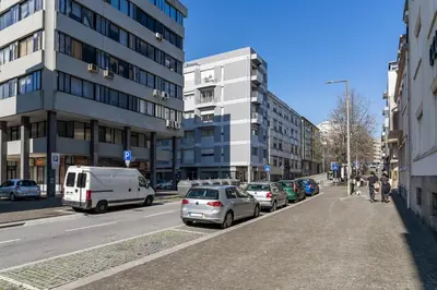 a city street with parked cars and buildings at Yellow Breeze Apartment by Cozy Stay in Porto