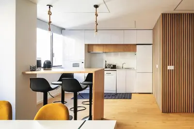 a kitchen with a wooden table and chairs at Yellow Breeze Apartment by Cozy Stay in Porto