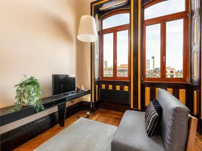 a living room with a couch and a window at Studio near Ribeira do Porto in Porto