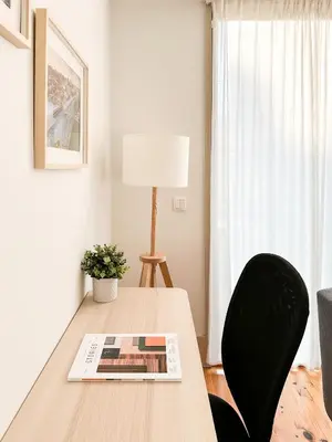 a dining room table with a book and a lamp at Ekaterine Uptown in Porto