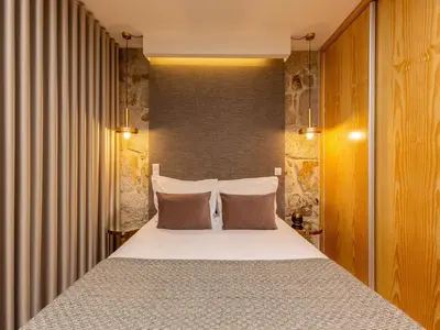a bedroom with a bed with two pillows at City Apartment with River Views in Vila Nova de Gaia