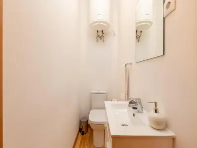 a white bathroom with a sink and a toilet at 2 Bedroom Apartment in Oporto in Porto