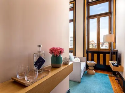 a room with a counter with a bottle and flowers on it at Centrally located apartment in Oporto in Porto