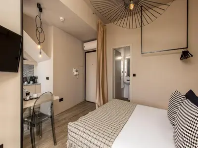a bedroom with a bed and a table and a desk at Apartment near picturesque Ribeira do Porto in Porto