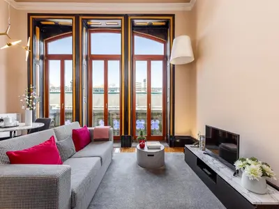 a living room with a couch and a tv at Cosy apartment in heart of Porto in Porto