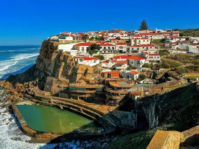 a village on a cliff next to the ocean at Central Porto apartment with balcony in Porto