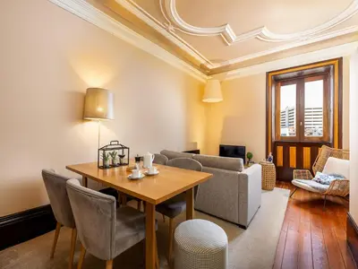 a living room with a table and a couch at Beach studio nearby market in Oporto in Porto