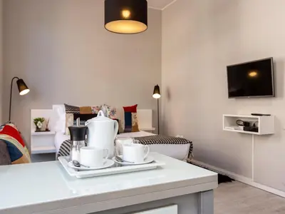 a living room with a table with dishes on it at Studio with balcony in Oporto in Porto