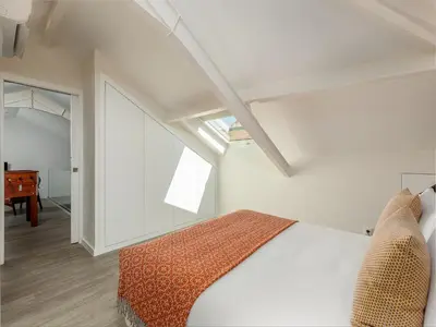 a bedroom with a bed and a window and a desk at Spacious 4-Bedroom Apartment in Porto in Porto