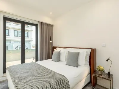 a bedroom with a bed and a large window at Spacious 4-Bedroom Apartment in Porto in Porto