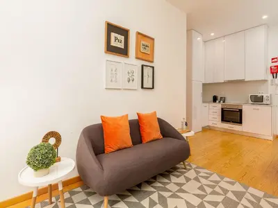 a living room with a couch and a table at Charming 1-Bedroom Apartment in Gaia in Porto