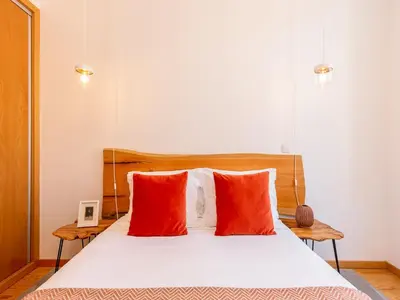 a bedroom with a bed with red pillows at Charming 1-Bedroom Apartment in Gaia in Porto