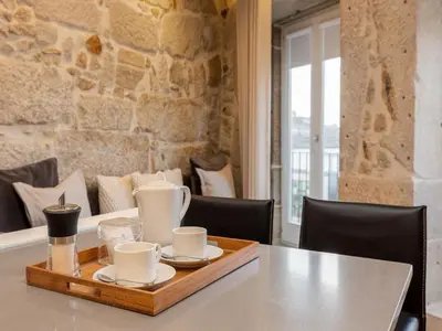 a tray with cups and plates on a table at Apartment in Vila Nova de Gaia in Vila Nova de Gaia