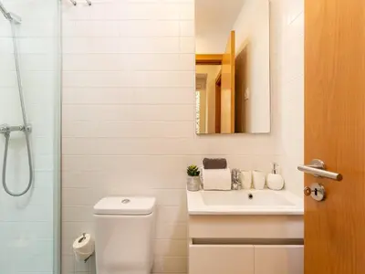 a bathroom with a toilet and a sink and a shower at Charming 1-Bedroom Apartment in Oporto in Porto