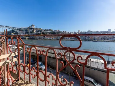 a bedroom with a large bed with two pillows at Charming riverview apartment in Porto in Porto