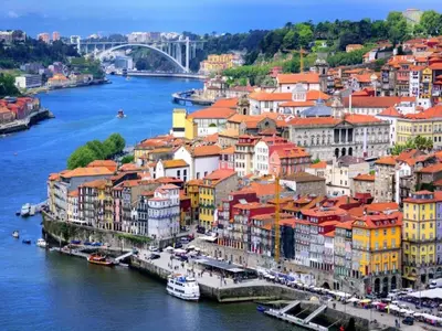 a group of boats in the water with a city at Well-equipped apartment in Oporto in Porto