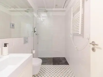 a white bathroom with a toilet and a sink at Central Porto with comfort & convenience in Porto