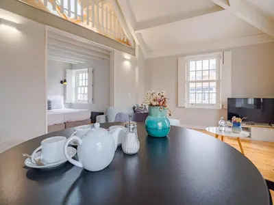a kitchen and living room with a table with tea pots at Comfortable apartment in Oporto in Porto