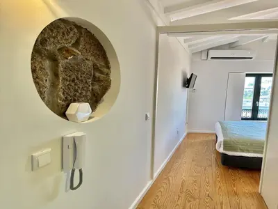 a living room with a round mirror on the wall at Charming apartment in Porto s Center in Porto