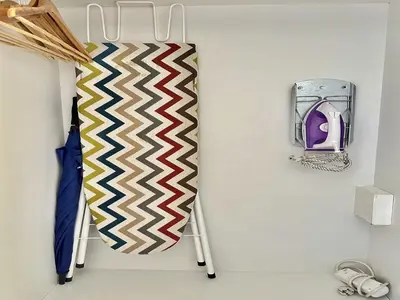 a rack with a tie and an umbrella on a wall at Charming apartment in Porto s Center in Porto