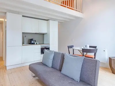 a living room with a couch and a table at Charming Porto apartment in prime location in Porto