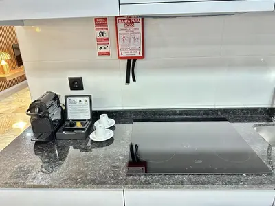 a counter with a cash register and a toaster at Bright apartment near Bolhao metro station in Porto