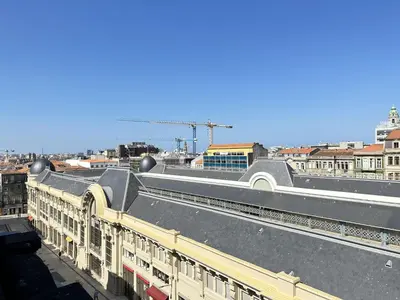 a train station with a train on the tracks at Bright apartment near Bolhao metro station in Porto