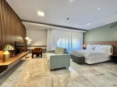 a hotel room with a bed and a chair at Bright apartment near Bolhao metro station in Porto