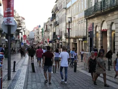 a group of people walking down a street at Charming studio, ideal for smaller groups in Porto