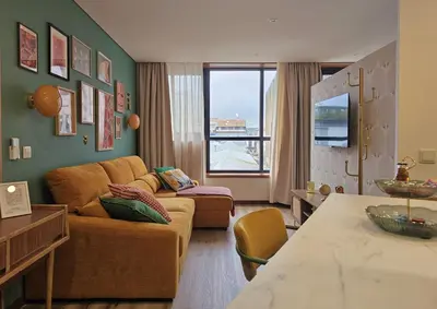 a living room with a couch and a table at Ninho Santa Catarina in Porto