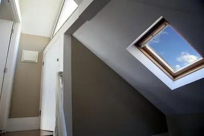 a skylight in a room with a window at Cedofeita Village in Porto