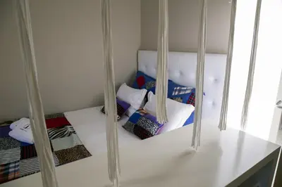 a room with several pillows and a shelf with mirrors at Cedofeita Village in Porto