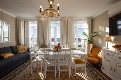 a living room with a white table and chairs at Cedofeita Village in Porto