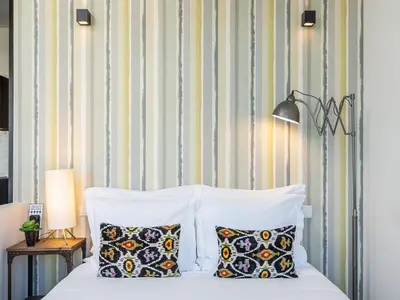 a bedroom with a bed with two pillows at Charming Apartment with street-view in Porto in Porto