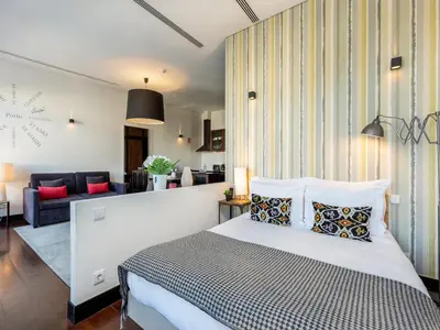 a bedroom with a bed and a living room at Charming Apartment with street-view in Porto in Porto