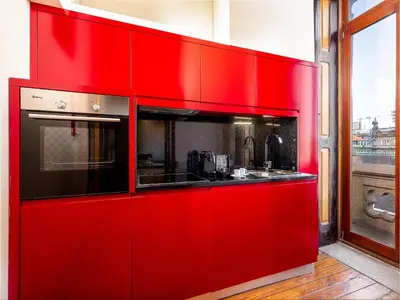 a red kitchen with a sink and a stove at Charming Apartment in Porto's Heart in Porto