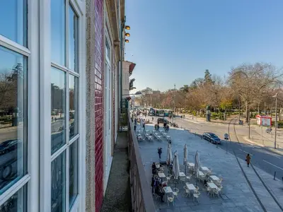 a view from a window of a building with tables and chairs at Apartment near Praia da Luz beach in Porto