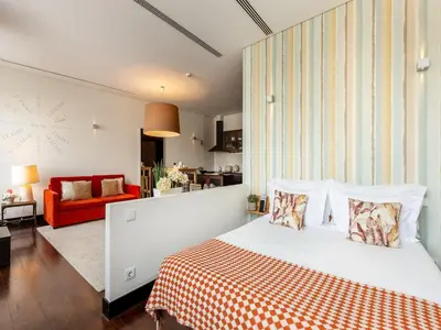 a bedroom with a bed and a living room at Apartment near Praia da Luz beach in Porto