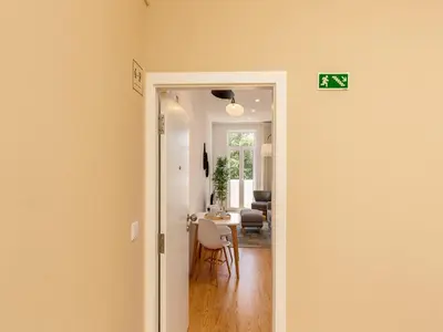 a hallway with a door leading to a living room at Stylish City-Center Retreat in Porto