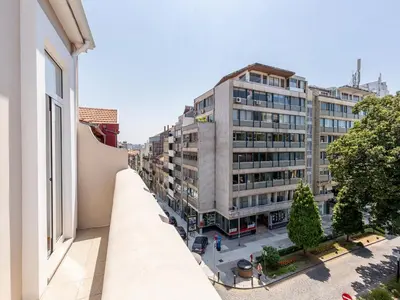an apartment balcony with a view of a city at Stylish City-Center Retreat in Porto