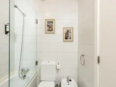 a bathroom with a tub and a toilet and a sink at Porto Pet-Friendly Stay in Porto