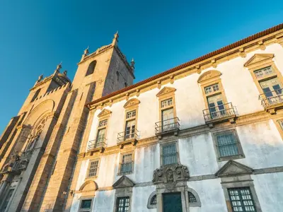 a large building with a clock tower on top of it at Charming Porto Studio Central & Cozy in Porto