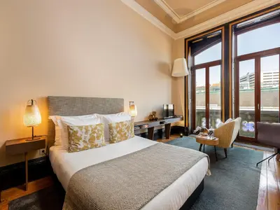a hotel room with a bed and a desk and window at Chic Porto Studio Cozy & Central Escape in Porto