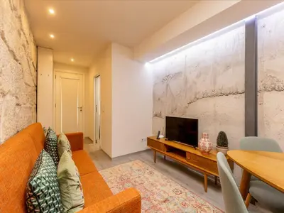 a living room with a couch and a tv at Beautiful apartment near Oporto city centre in Porto