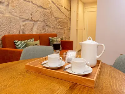 a tray with cups and plates on a table at Beautiful apartment near Oporto city centre in Porto