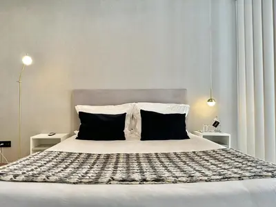 a bedroom with a large bed with two pillows at Compact & Cozy Retreat in Porto s Heart in Porto
