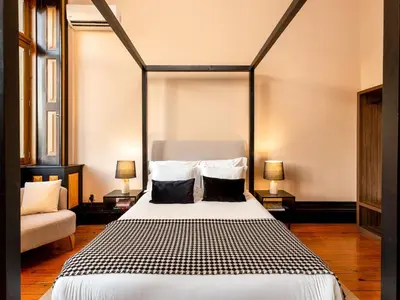 a bedroom with a large bed and a couch at Spacious Modern Apartment in Porto in Porto